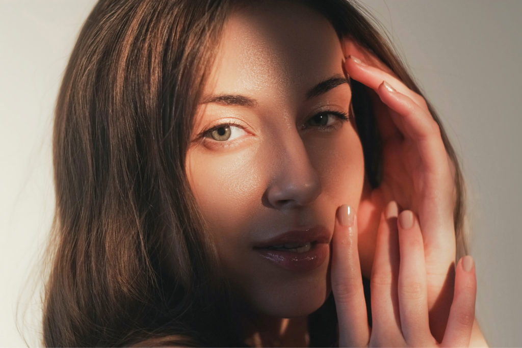Glowing skin of a woman in natural light at the PSC Atlanta clinic after HydraFacial treatment, showcasing smooth and rejuvenated skin.